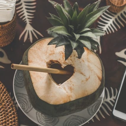 Coconut Juice With Bamboo Straw Near Smartphone